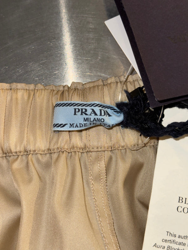 Prada Re Nylon Beige Drawstring Shorts Elastic Waist Wide Leg Enamel Triangle Logo Technical Fabric Sporty Designer Bermuda Shorts New with Tags Size IT 46