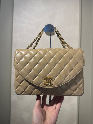 Chanel Beige Small Curved Flap Quilted Lambskin Vintage CC Half Moon Single Flap Shoulder 24k Gold chain Hardware Classic Iconic